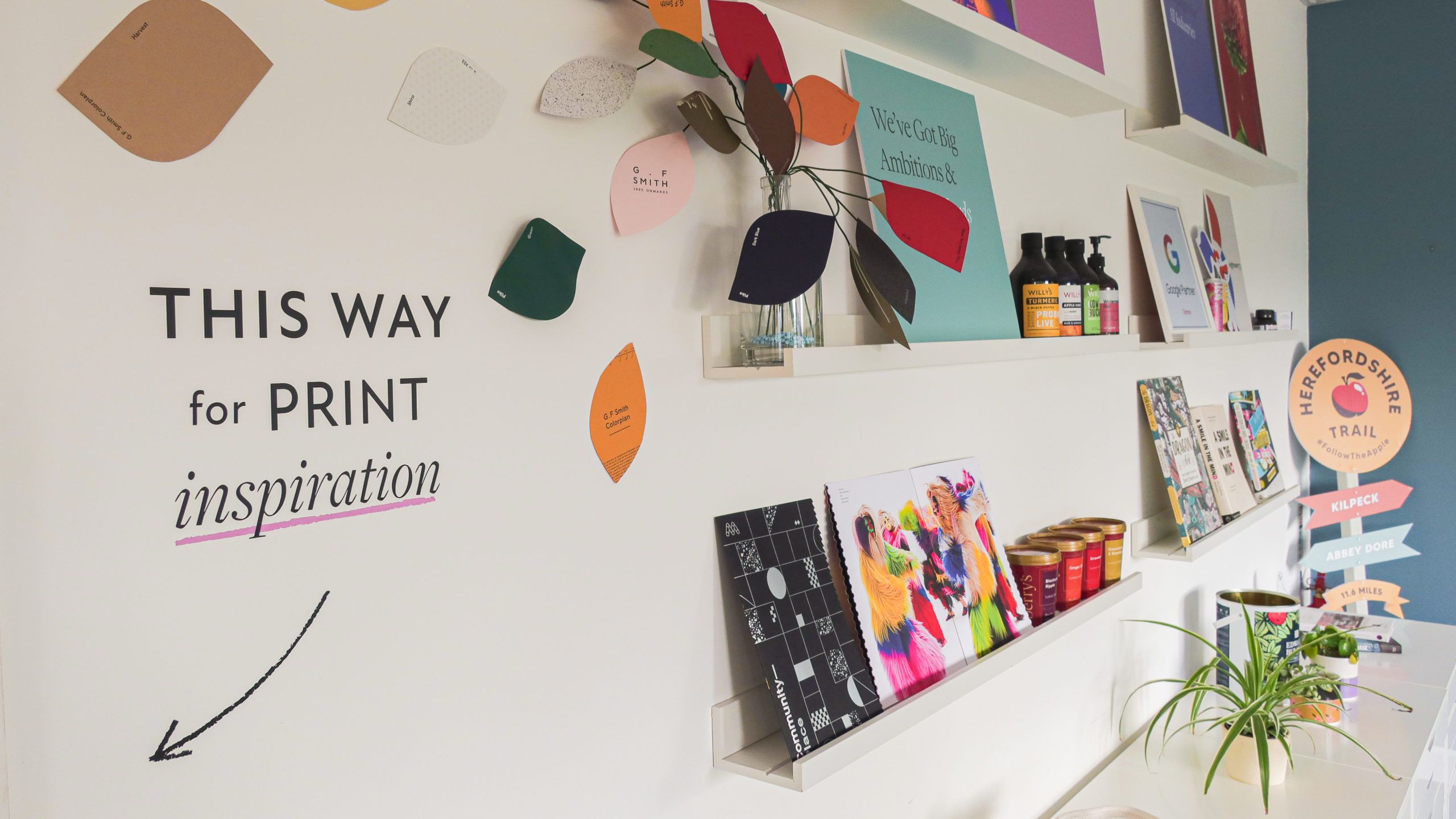 Print samples on shelves with vinyl reading "This way for Print Inspiration"